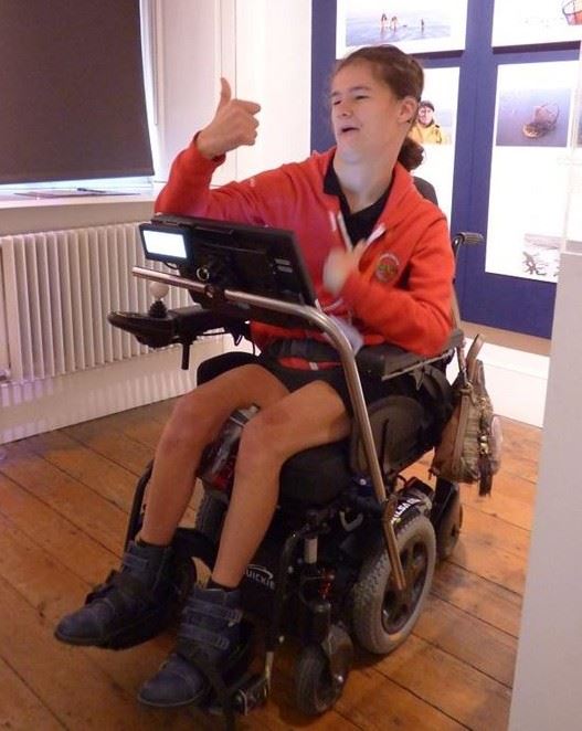 photo of young woman in electric wheelchair.